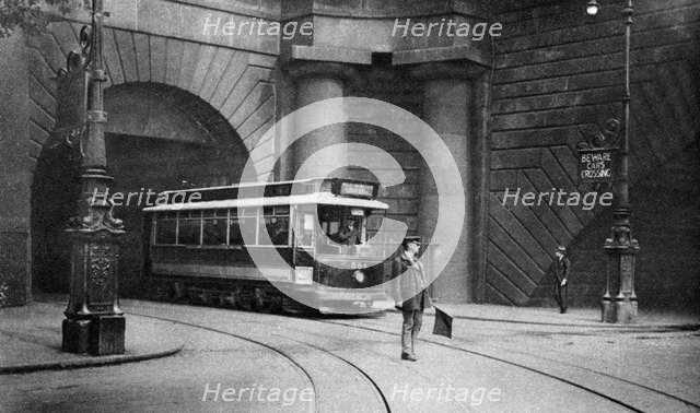 A tram running beneath Kingsway, Aldwych and Somerset House, London, 1926-1927. Artist: Unknown