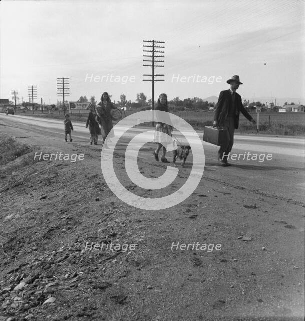 Homeless family of seven, walking the highway..., on U.S. 99, near Brawley, Imperial County, 1939. Creator: Dorothea Lange.
