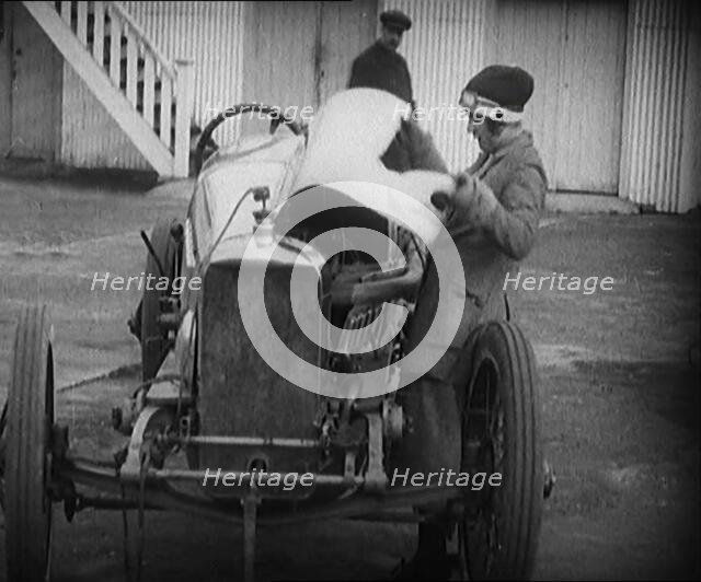 Racing Driver Ivy Cummins Wearing a Racing Outfit Opening a Bonnet of Her Car, 1920. Creator: British Pathe Ltd.