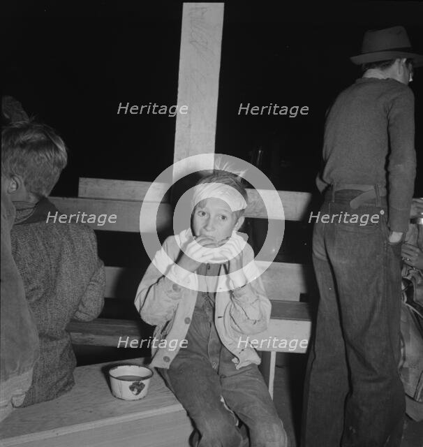 Hungry boy at the Halloween party for migrant workers, Shafter migrant camp, California, 1938. Creator: Dorothea Lange.