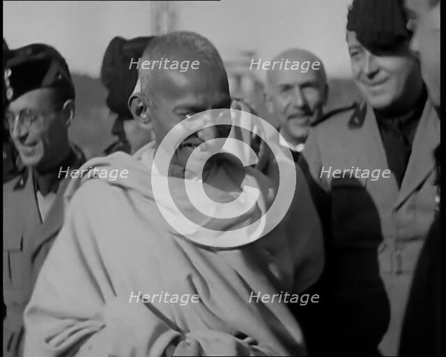 Mahatma Gandhi Standing with Others, 1930s. Creator: British Pathe Ltd.