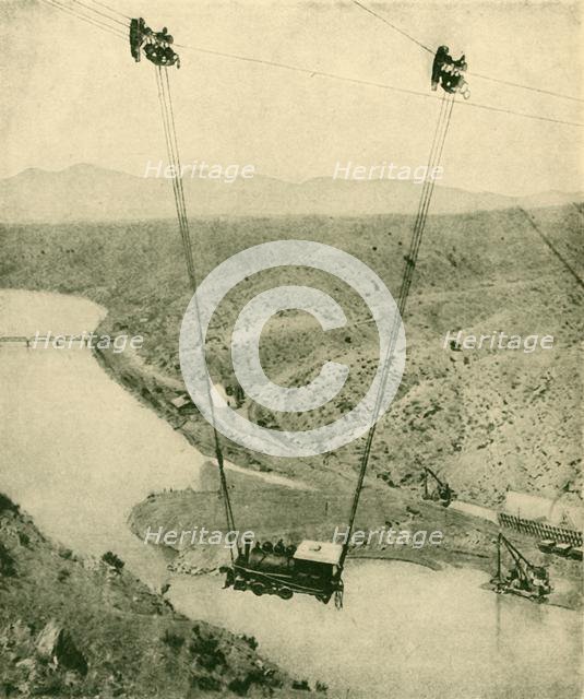 'A Contractor's Engine Being Swung Across A Canyon, Rio Grande River, New Mexico', 1930. Creator: Unknown.