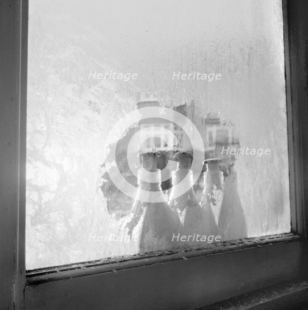 Frozen milk bottles, 1960-1965. Artist: John Gay