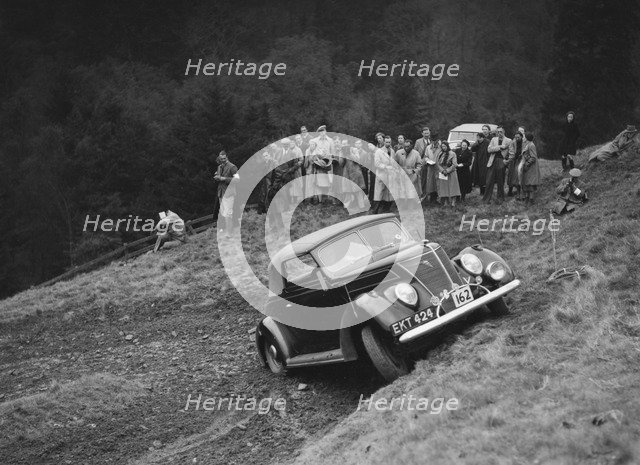 Ford V8 of J Cleland competing in the MCC Edinburgh Trial, Roxburghshire, Scotland, 1938. Artist: Bill Brunell.
