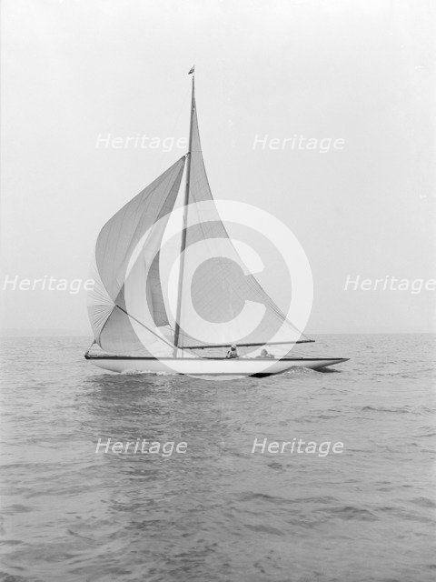 The 6 Metre class 'Marmi' sailing under spinnaker, 1914. Creator: Kirk & Sons of Cowes.