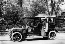 Woman stands by a 1907/8 Daimler. Artist: Unknown