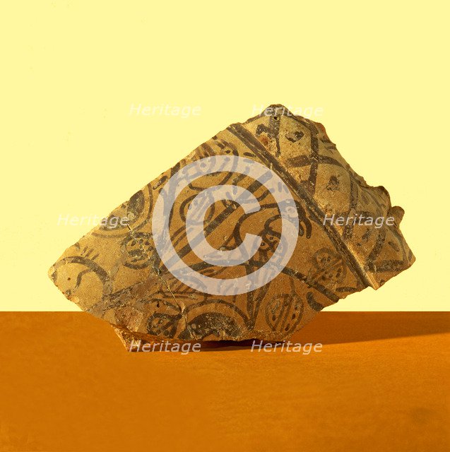 Basil collector, fragment decorated with pomegranates, with a bird resting on a branch. It belong…