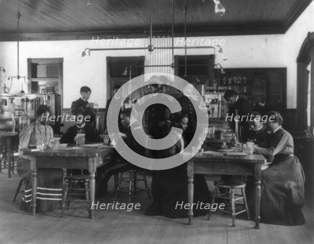 Chemistry classroom at Hampton Institute - African American male and female students, 1899 or 1900. Creator: Frances Benjamin Johnston.