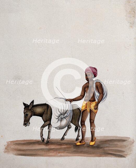 A man walking along with a donkey carrying a heavy load, (between 1800 and 1899?). Creator: Unknown.