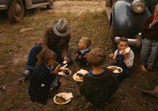 Homesteader and his children eating barbeque at the Pie Town, New Mexico Fair, 1940. Creator: Russell Lee.