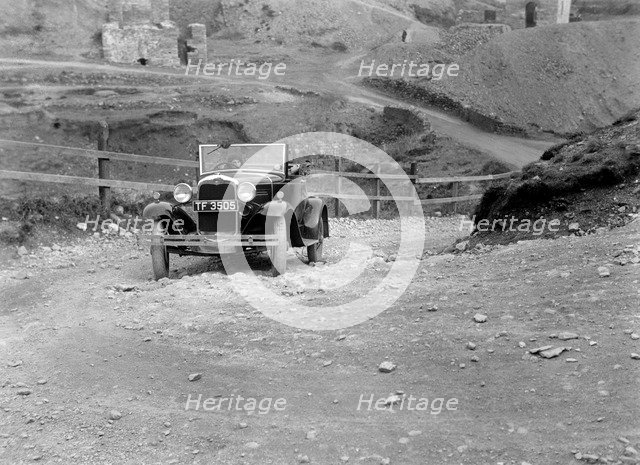Kitty Brunell driving a 1930 Ford Model A 2-seater, 1931. Artist: Bill Brunell.