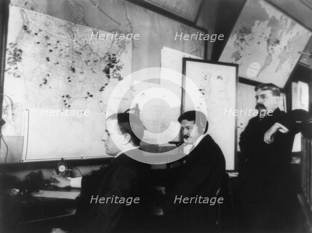E.C. Heasley, Jules A. Rodier and Maj. Montgomery in the telegraph room in the White House..., 1898. Creator: Frances Benjamin Johnston.