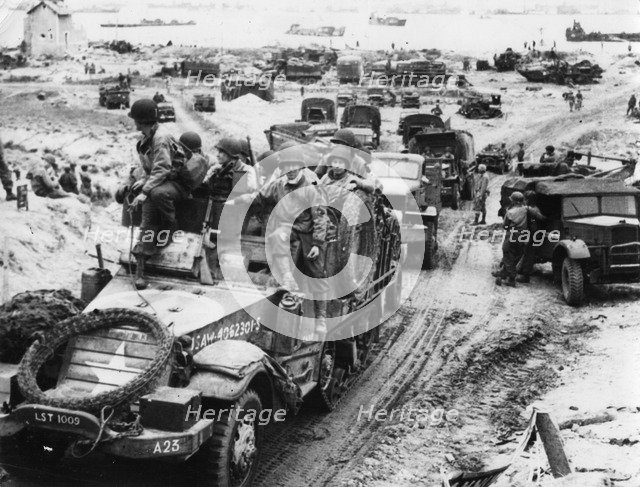 Supplies and troops move inland, Normandy beaches, France, 6 June 1944. Artist: Unknown