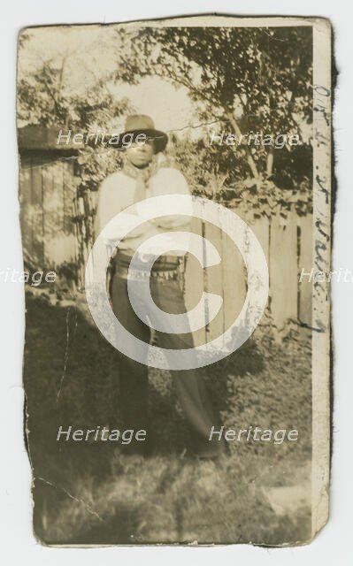 Photographic portrait of a man wearing hat and gun holster, early 20th century. Creator: Unknown.