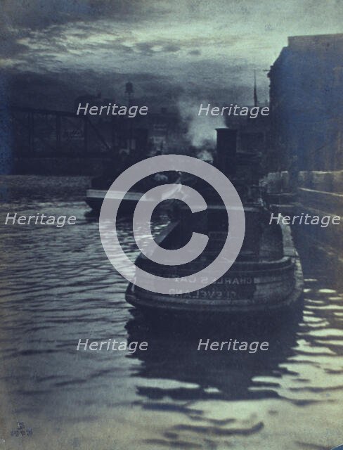 Rear view of tugboats approaching a wharf, possibly in Cleveland, Ohio, 1903. Creator: Unknown.