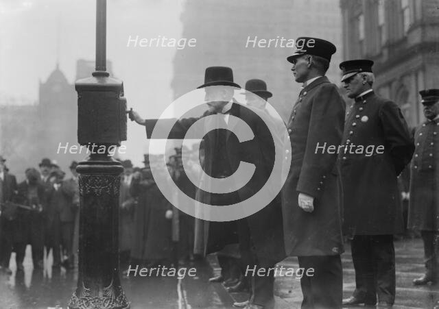 Mayor Gaynor turning in alarm 3/20/13, 1913. Creator: Bain News Service.