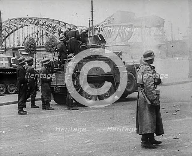 German Soldiers Standing Next to a Truck-Mounted Gun, 1942. Creator: British Pathe Ltd.
