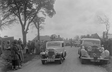 Austin sports saloon of Mrs MS Flewitt and Rolls-Royce saloon at the RSAC Scottish Rally, 1934. Artist: Bill Brunell.