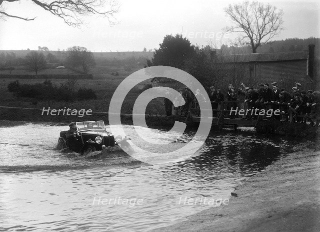 MG Magnette driving through a ford during a motoring trial, 1936. Artist: Bill Brunell.