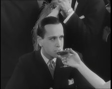 Scene from the Film 'Champagne': Betty Balfour in a Nightclub Drinking Champagne and Giving...,1920s Creator: British Pathe Ltd.