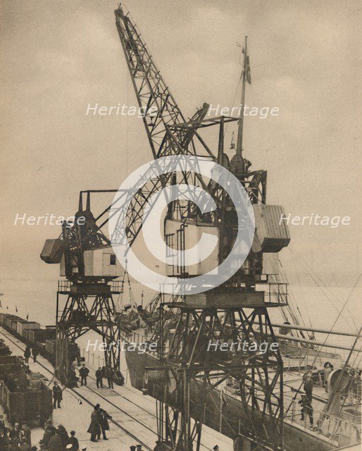 'Huge Mobile Cranes at Tilbury Swing the Cargo from a Vessel's Hold', c1935. Creator: Unknown.
