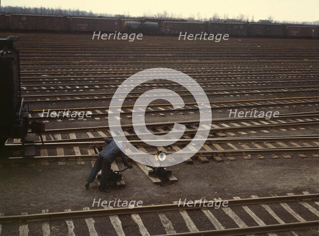 Switchman throwing a switch at C & NW RR's Proviso yard, Chicago, Ill., 1943. Creator: Jack Delano.