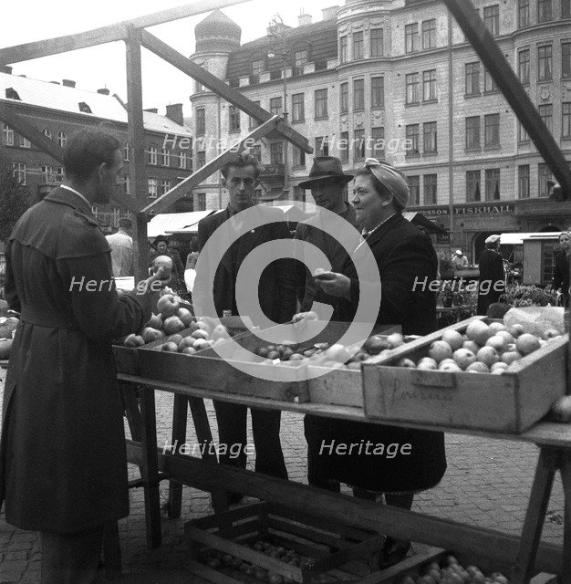 Fruit and vegetable stall in the market, Malmö, Sweden, 1947. Artist: Otto Ohm