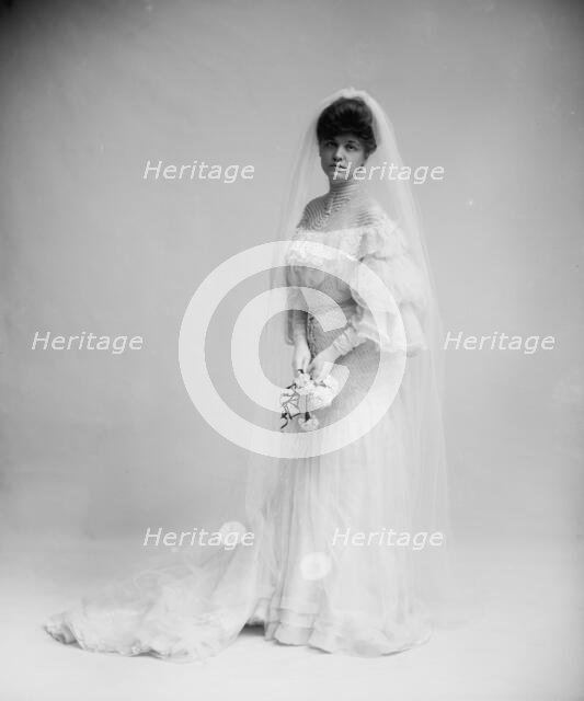 Woman in wedding dress holding flowers, between 1900 and 1910. Creator: Unknown.