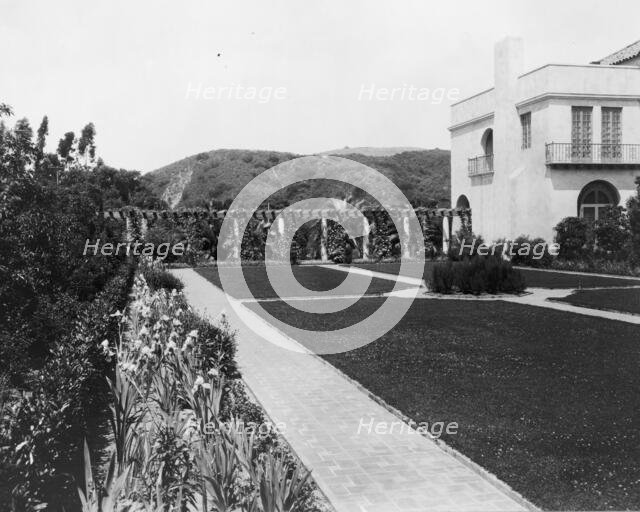 Pasadena, California, Mrs. Herbert Coppell home - view of formal lawn, gardens, and hills..., 1917. Creator: Frances Benjamin Johnston.