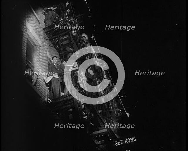 Male Civilians Watching a Female Civilian in Traditional Robe Performing With Sabres..., 1932. Creator: British Pathe Ltd.