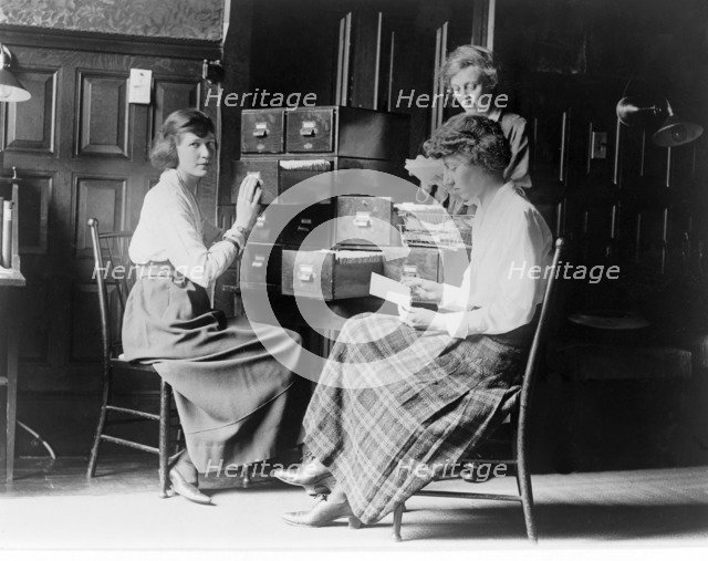 Three women work at the card index files at the headquarters of the National Woman's Party, c.1920.