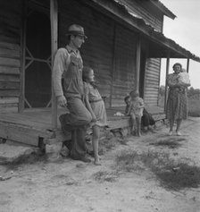 Tobacco sharecropper with his oldest daughter, Person County, North Carolina, 1939. Creator: Dorothea Lange.