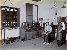 Johannesburg Hospital, South Africa: man in heavy apron, face mask and glove, possibly..., c1905. Creator: Unknown.