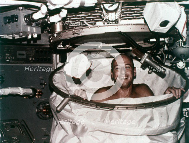 Conrad in shower facility aboard Skylab 2, 1973. Creator: NASA.