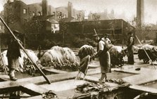 Making leather in the lime yard at Neckinger Mills, London, 20th century. Artist: Unknown