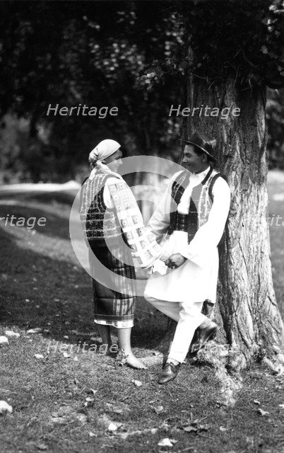 Couple in traditional costume, Bistrita Valley, Moldavia, north-east Romania, c1920-c1945.  Artist: Adolph Chevalier