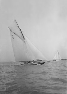 Mrs GA Shenley at the helm of the 8 Metre class 'Spero' (H8). Creator: Kirk & Sons of Cowes.