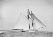 The 250 ton schooner 'Germania' sailing downwind with spinnaker, 1912. Creator: Kirk & Sons of Cowes.