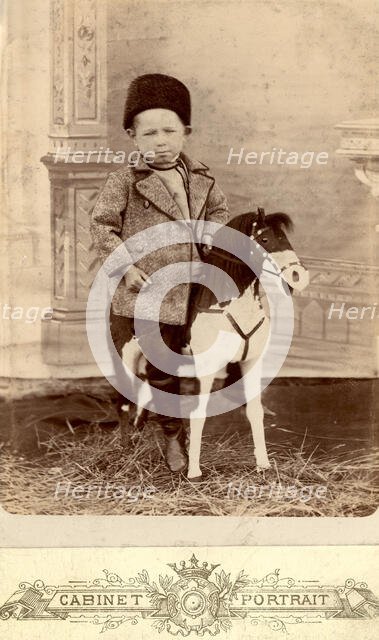 Portrait of a boy sitting on a toy horse, late 19th cent - early 20th cent. Creator: Unknown.