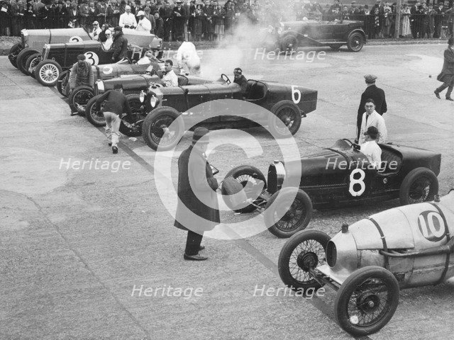 Cars on the start line at a BARC meeting, Brooklands, 1930. Artist: Bill Brunell.