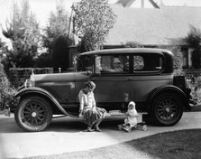 Stan Laurel at the wheel of 1927 Hupmobile with his wife Lois and daughter Lois  Artist: Unknown.