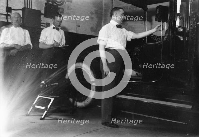 John Drennen inspecting meter, 1913. Creator: Bain News Service.