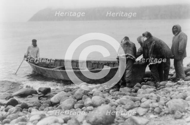 Launching the boat-Little Diomede Island, c1928. Creator: Edward Sheriff Curtis.