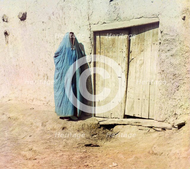 Woman in purdah, standing near wooden door, between 1905 and 1915. Creator: Sergey Mikhaylovich Prokudin-Gorsky.