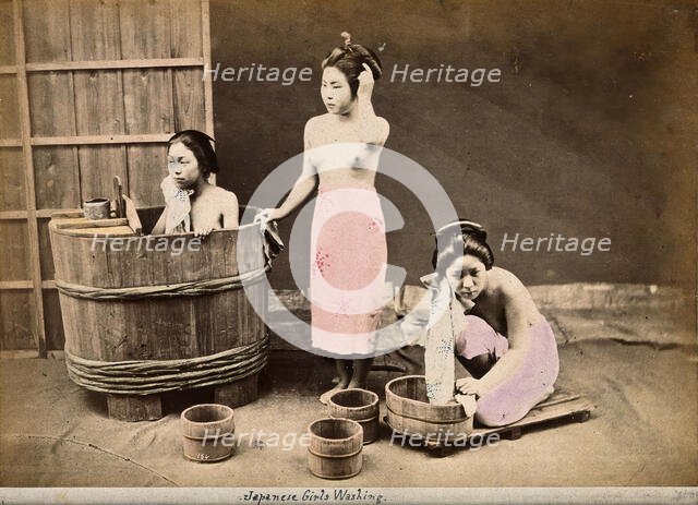 Three Japanese women washing: One in a wooden tub, one standing and one crouching..., c1890s. Creator: Unknown.