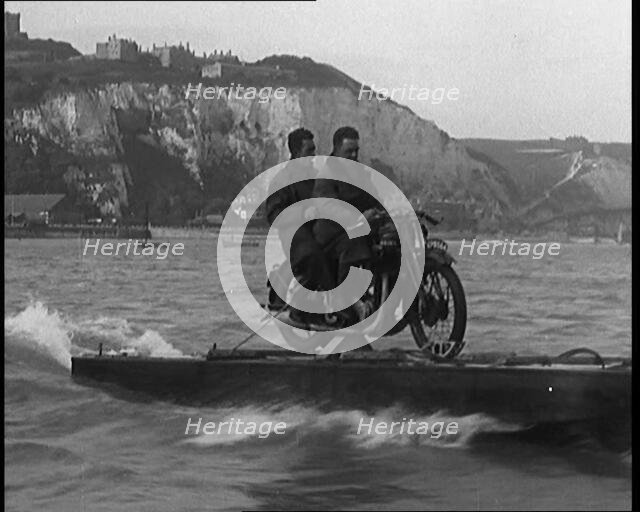 Two Male Civilians Riding a Motorcycle on a Float Across the English Channel, 1929. Creator: British Pathe Ltd.