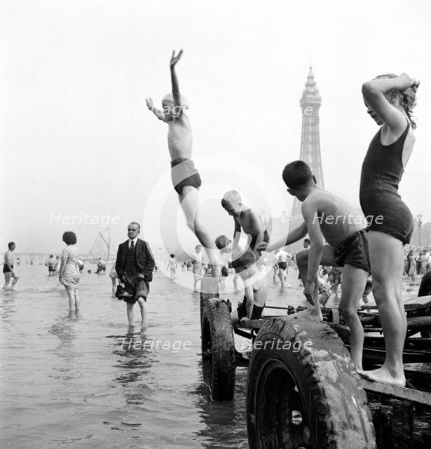 Children in swimming costumes jump into the sea, Blackpool, c1946-c1955. Artist: John Gay