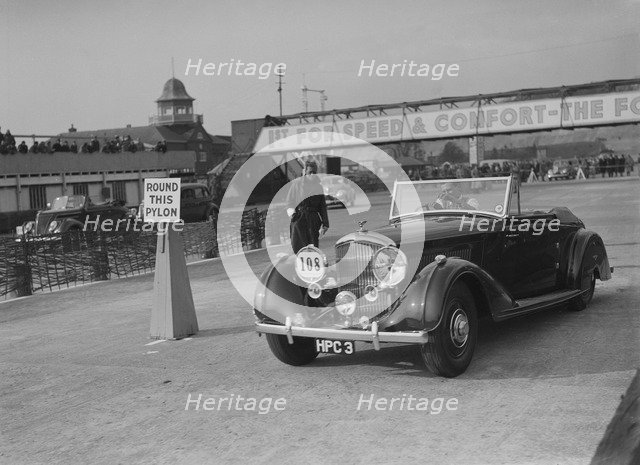Bentley 4-seater tourer of GG Wood competing in the JCC Rally, Brooklands, Surrey, 1939. Artist: Bill Brunell.