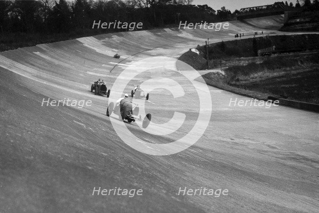 CS Staniland's Bugatti Type 37A leading a Benz and Jack Dunfee's Ballot, Brooklands, 1930. Artist: Bill Brunell.