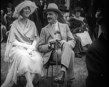 Female Civilian and Male Civilian Sitting on Chairs, 1924. Creator: British Pathe Ltd.